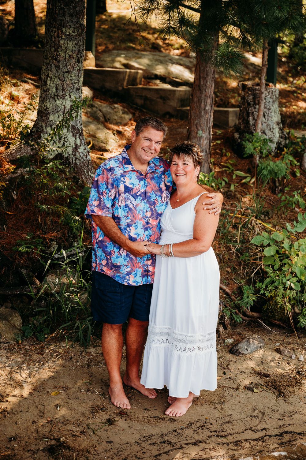 Couple posing in front of pine trees on Lake Vermilion, Cook, Minnesota.