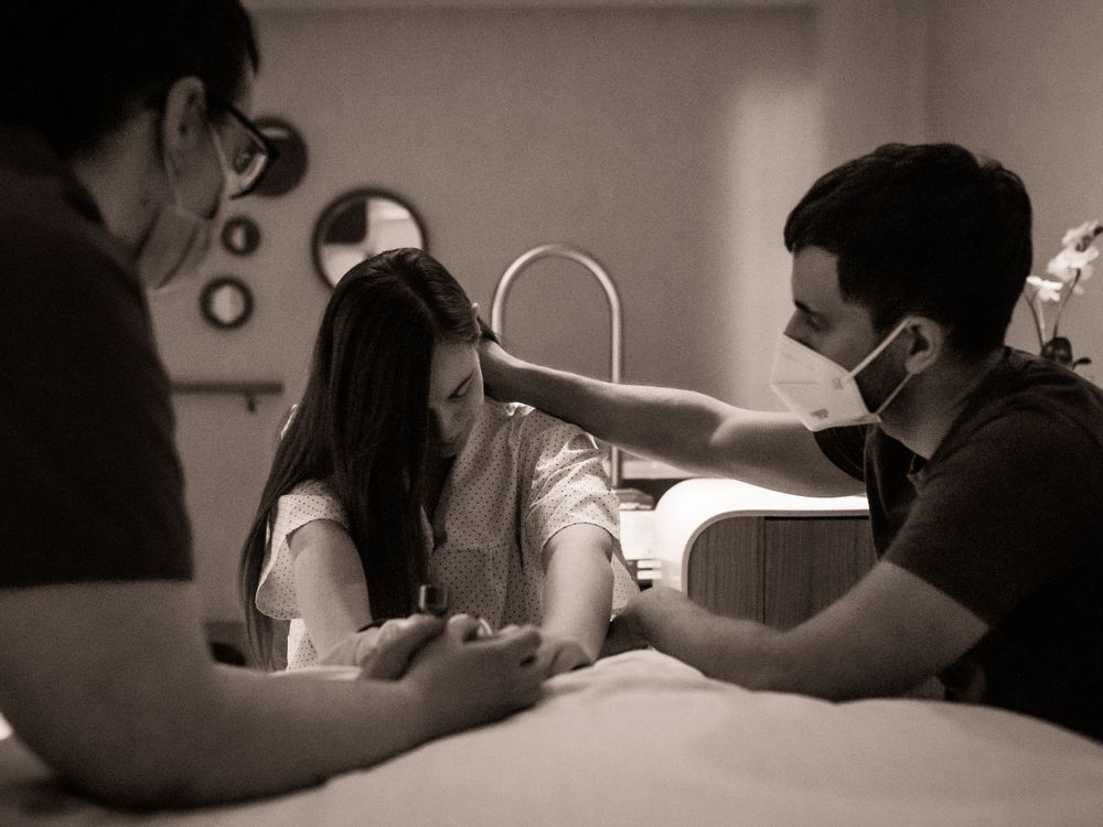 Monochrome sequence of two people interacting on a bed in dramatic lighting.