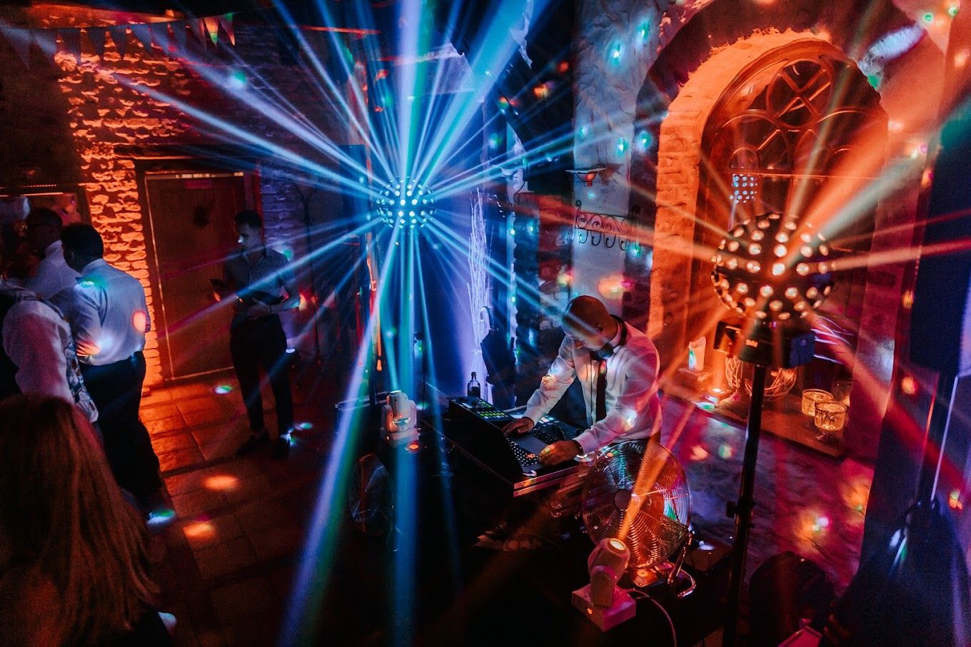 Dynamic blue and red lighting creates a dramatic atmosphere on a nightclub dance floor.
