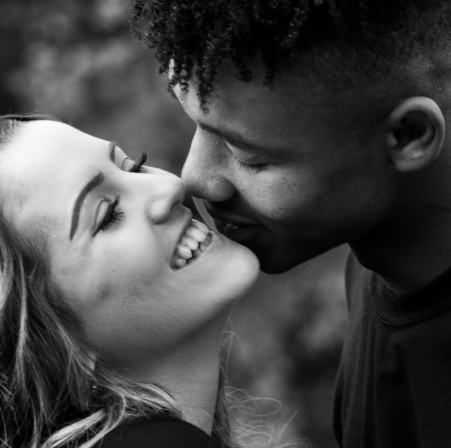 Intimate black and white close-up of a couple sharing a romantic moment.