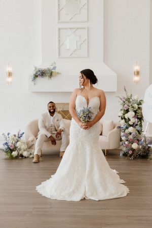 Wedding portrait setup with soft pastel florals and elegant white decor.