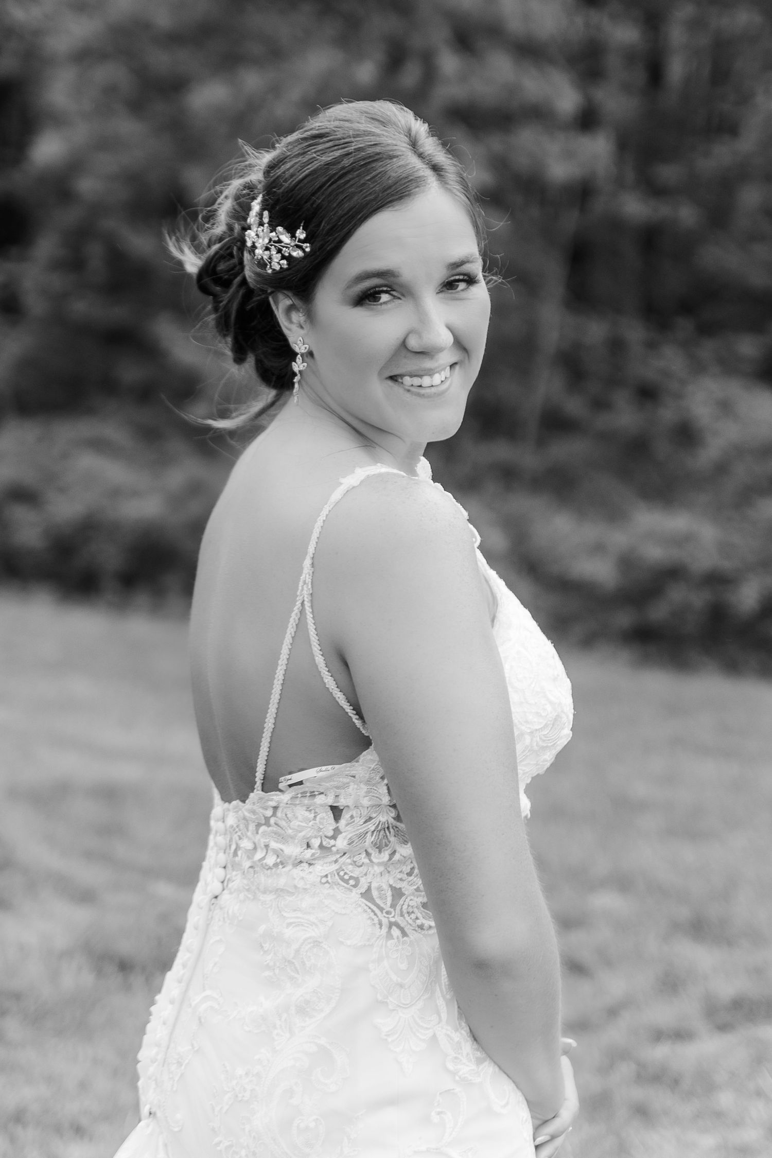 A series of bridal portraits showing the back details of a white lace wedding dress in black and white.