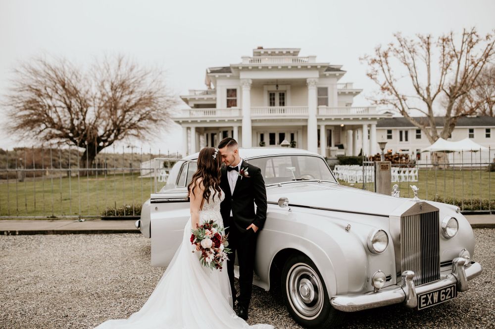 Bride and Groom stand beside vintage Rolls Royce outside of The Moore Mansion in Pasco, WA.