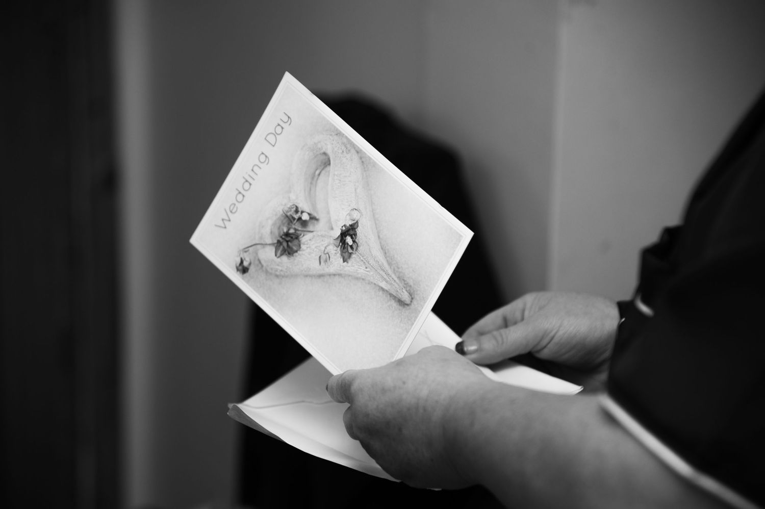 Black and white photo of hands holding a photograph or document.