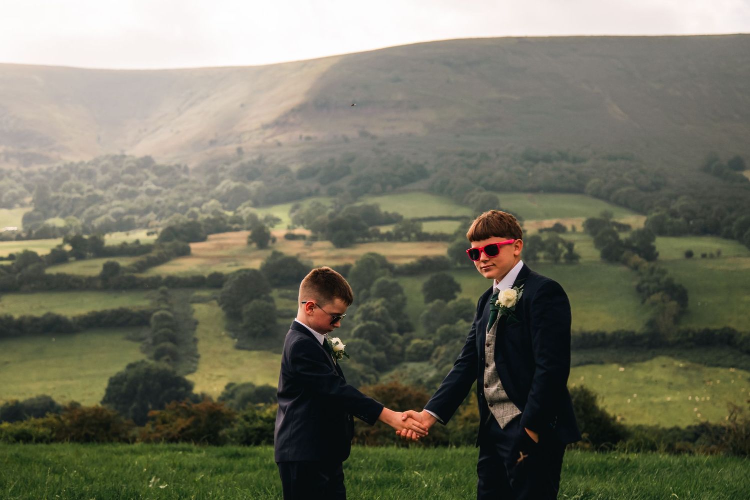 Scenic panoramic view of rolling green hills and countryside during an outdoor wedding celebration.