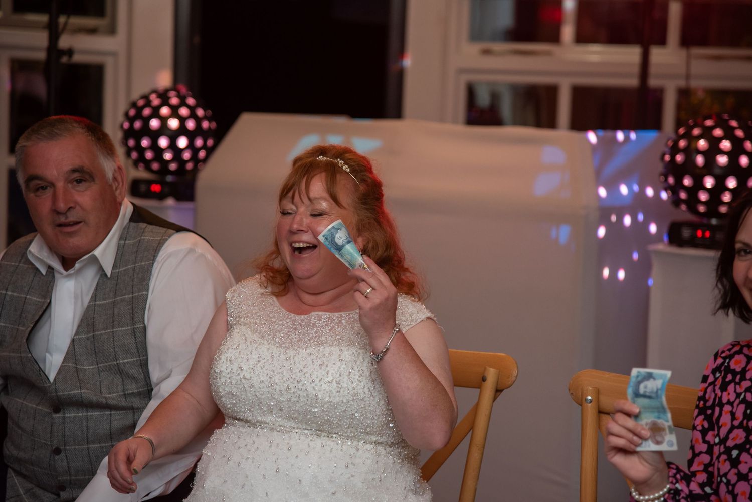 Wedding reception dance floor with festive polka dot decorations and string lights.