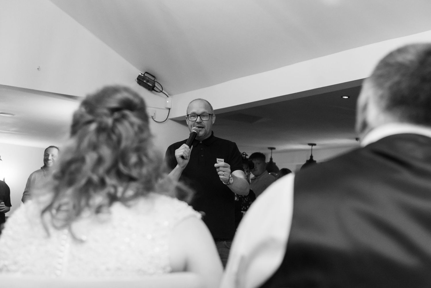 Blurred black and white candid shots of wedding reception guests.