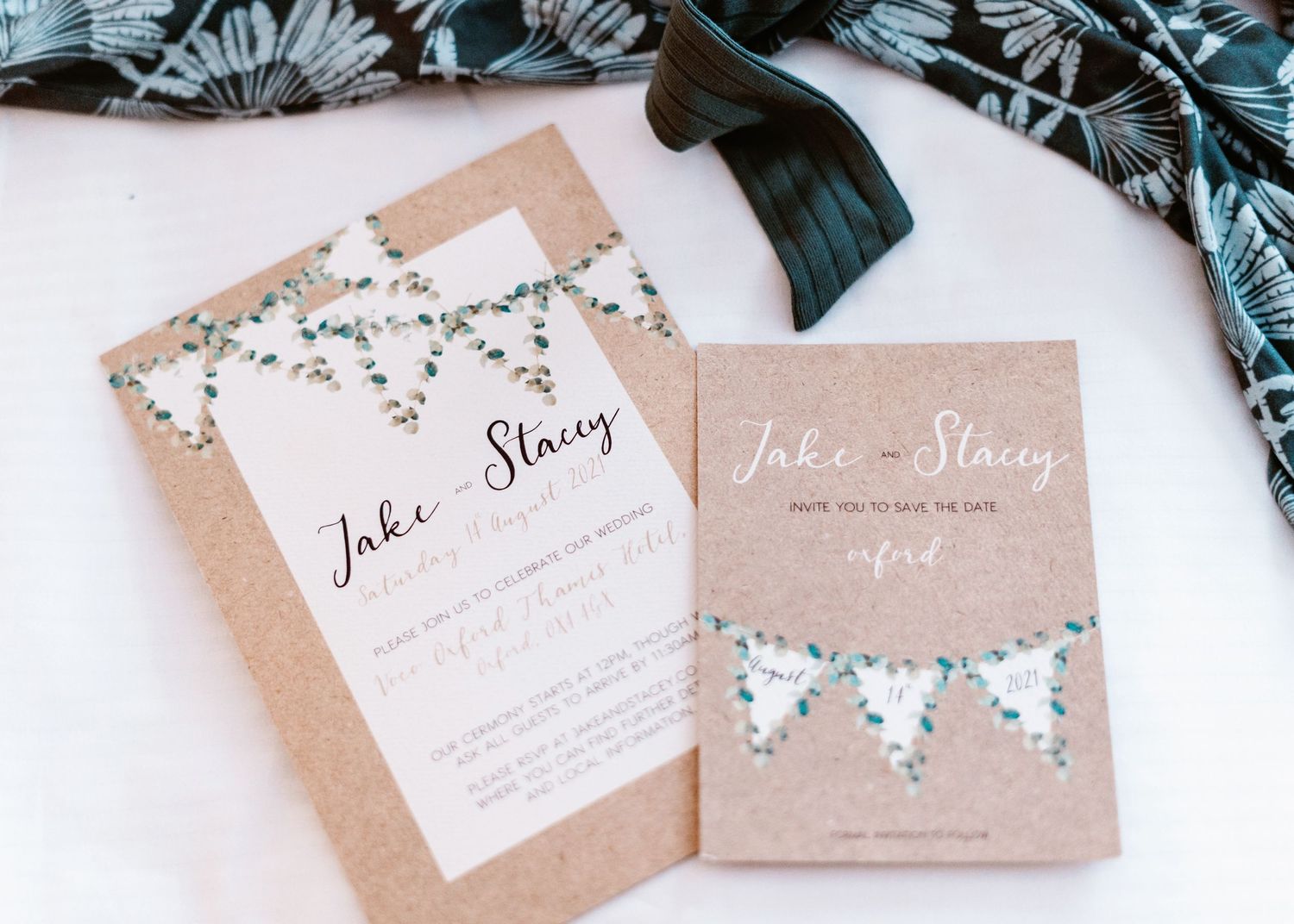 Rustic wedding invitations with floral details and kraft paper design.