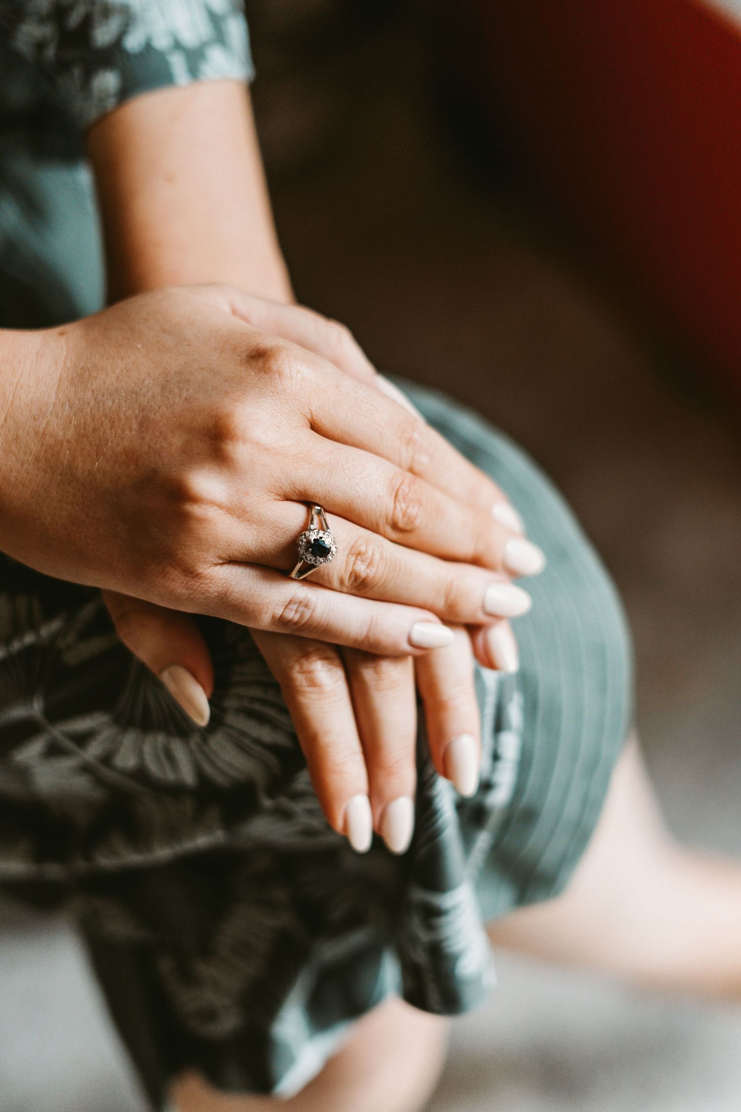 Close-up of hands with engagement and wedding rings.