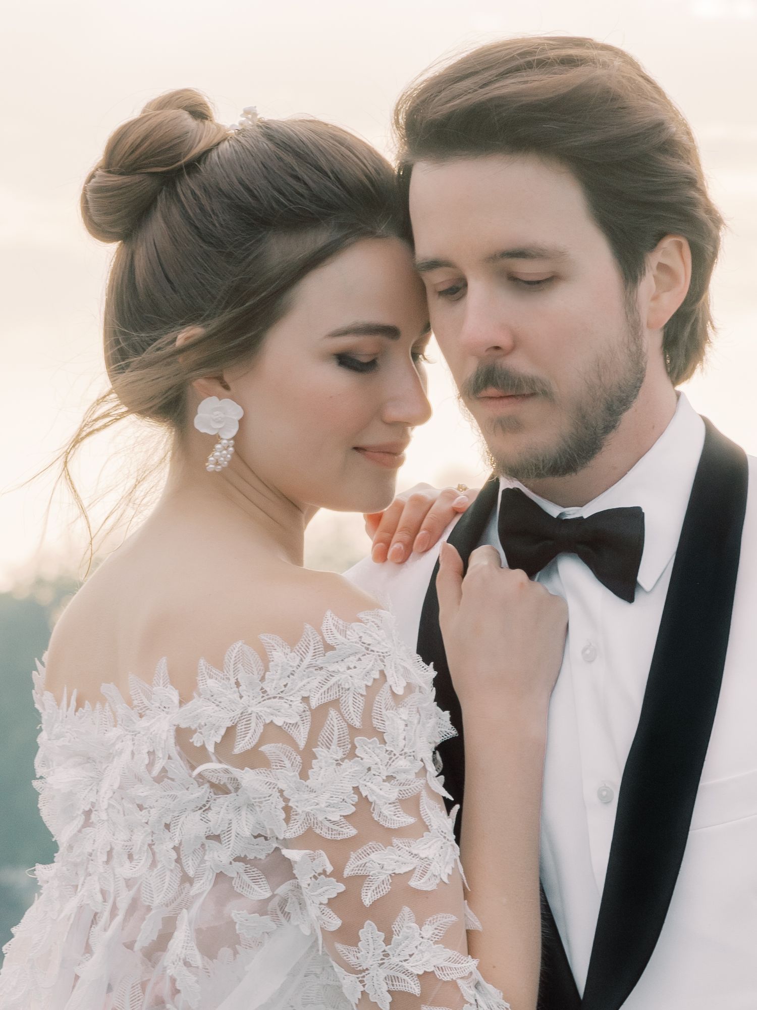 An intimate wedding portrait with delicate lace details and classic formal wear.