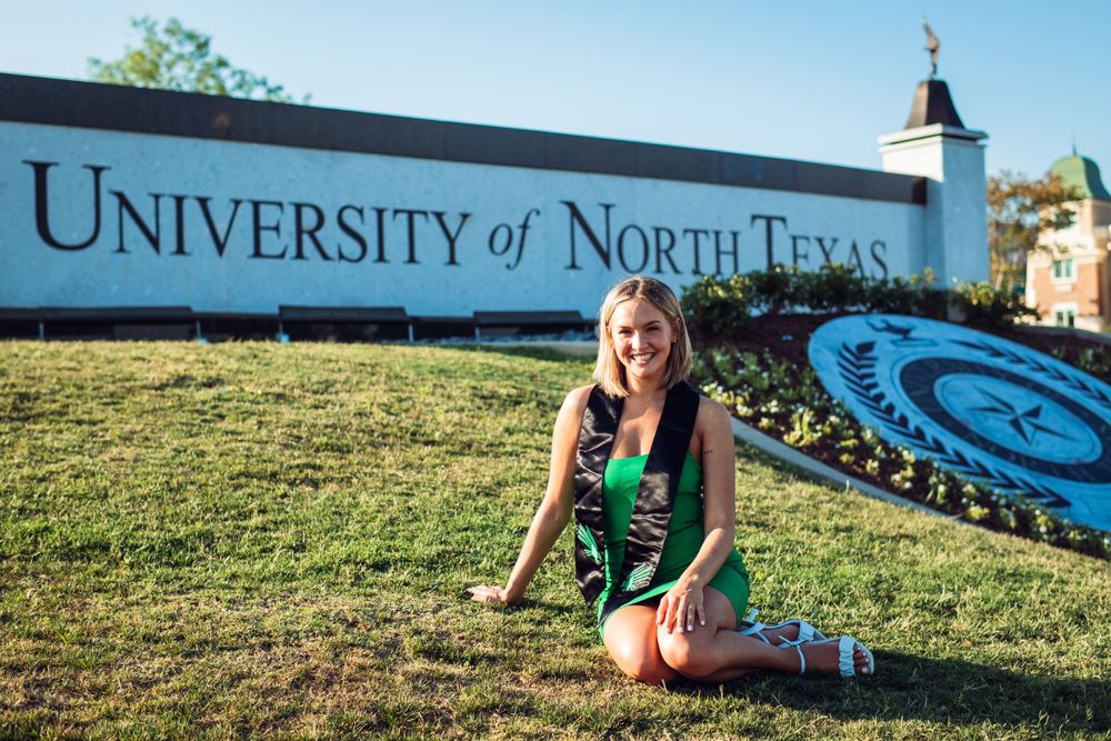 Scenic view of University of North Texas campus buildings and signage on a sunny day.