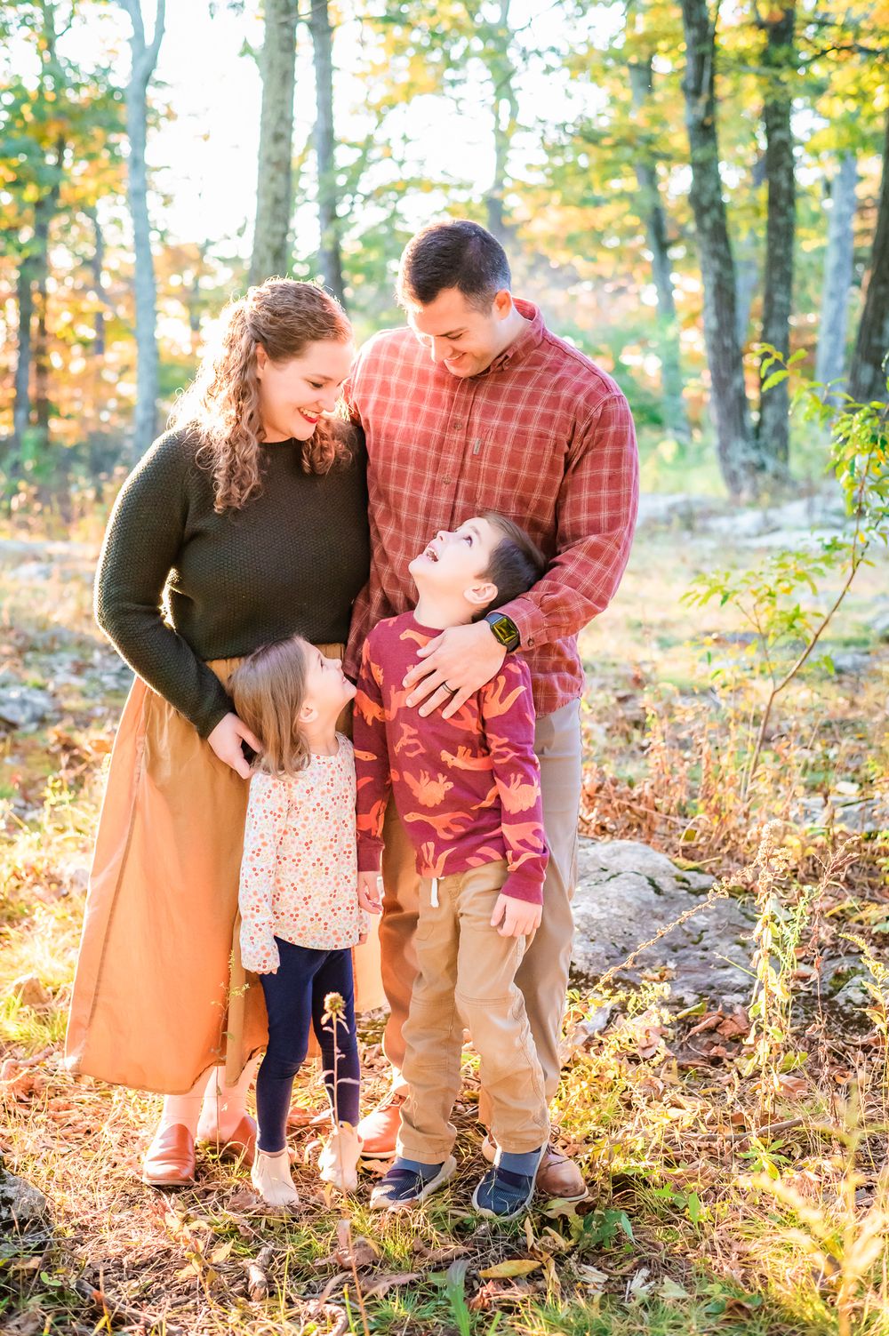 Warm fall photo of Mother and Father looking at son and daughter in Frederick Maryland