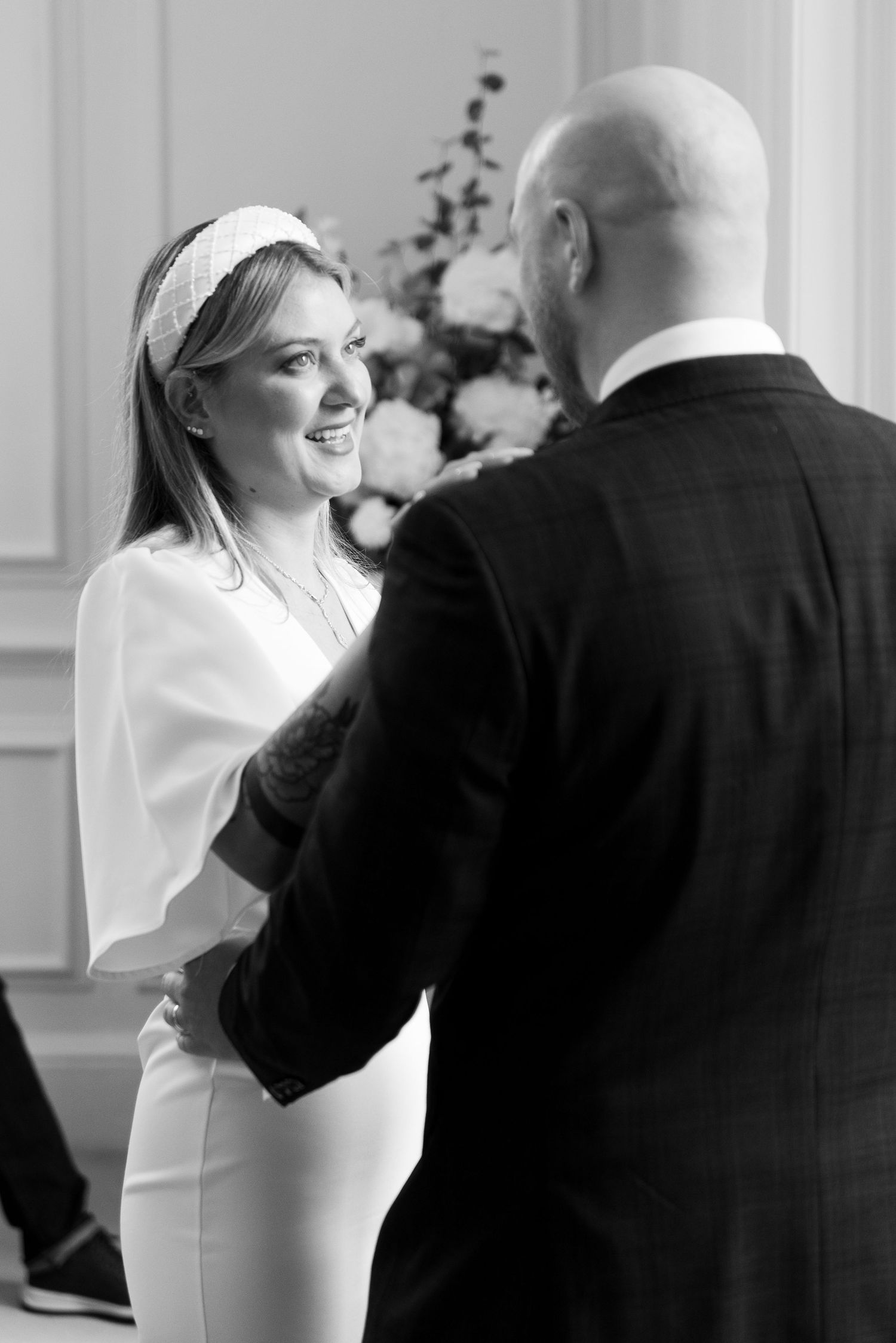 Black and white candid photo of joyful couple during wedding ceremony.