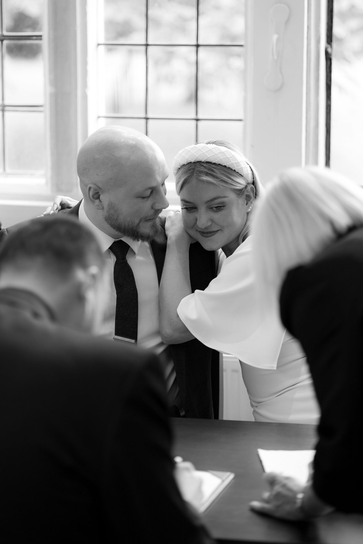 Intimate black and white moment between couple during wedding ceremony.