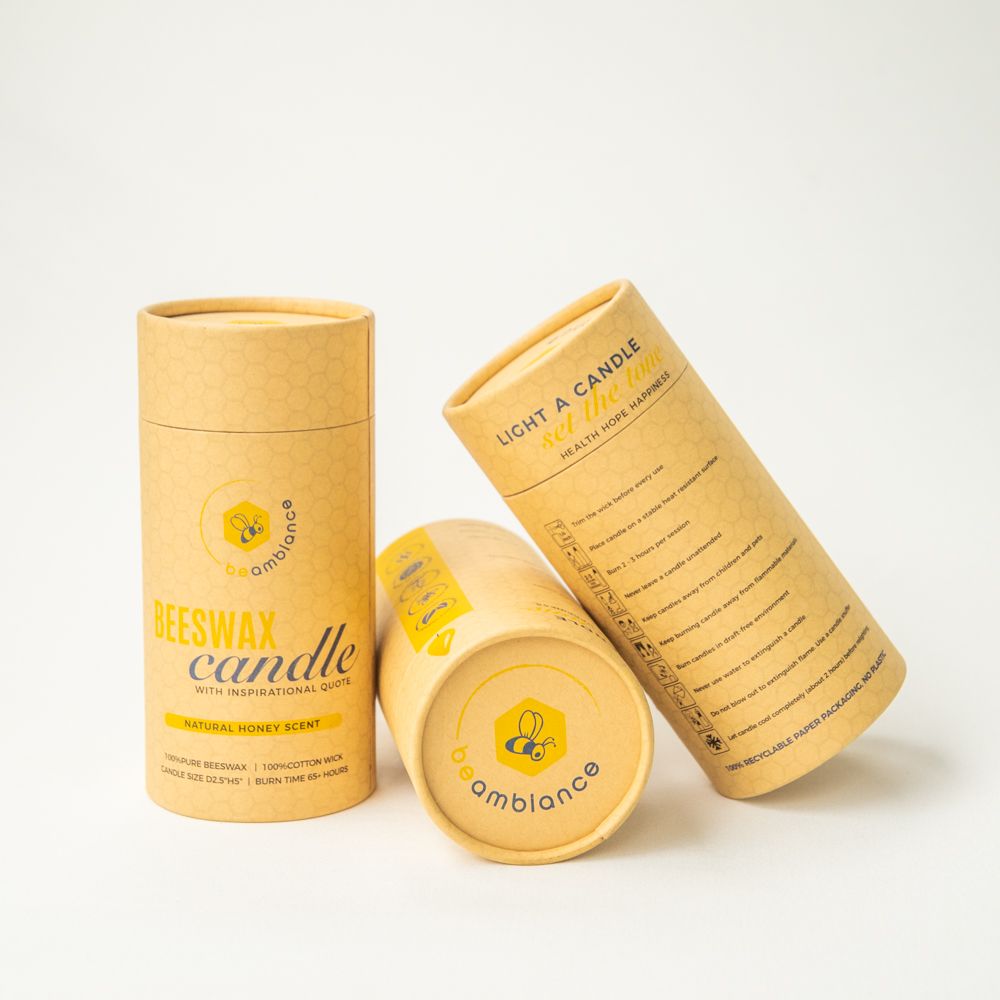 Beeswax candle products with eco-friendly packaging displayed on white surface.