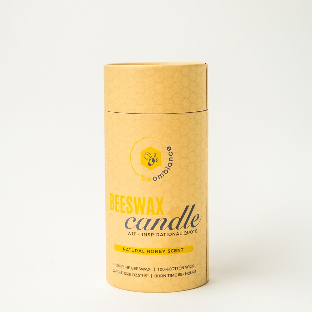 A cylindrical yellow packaging container for beeswax candle with natural honey scent.