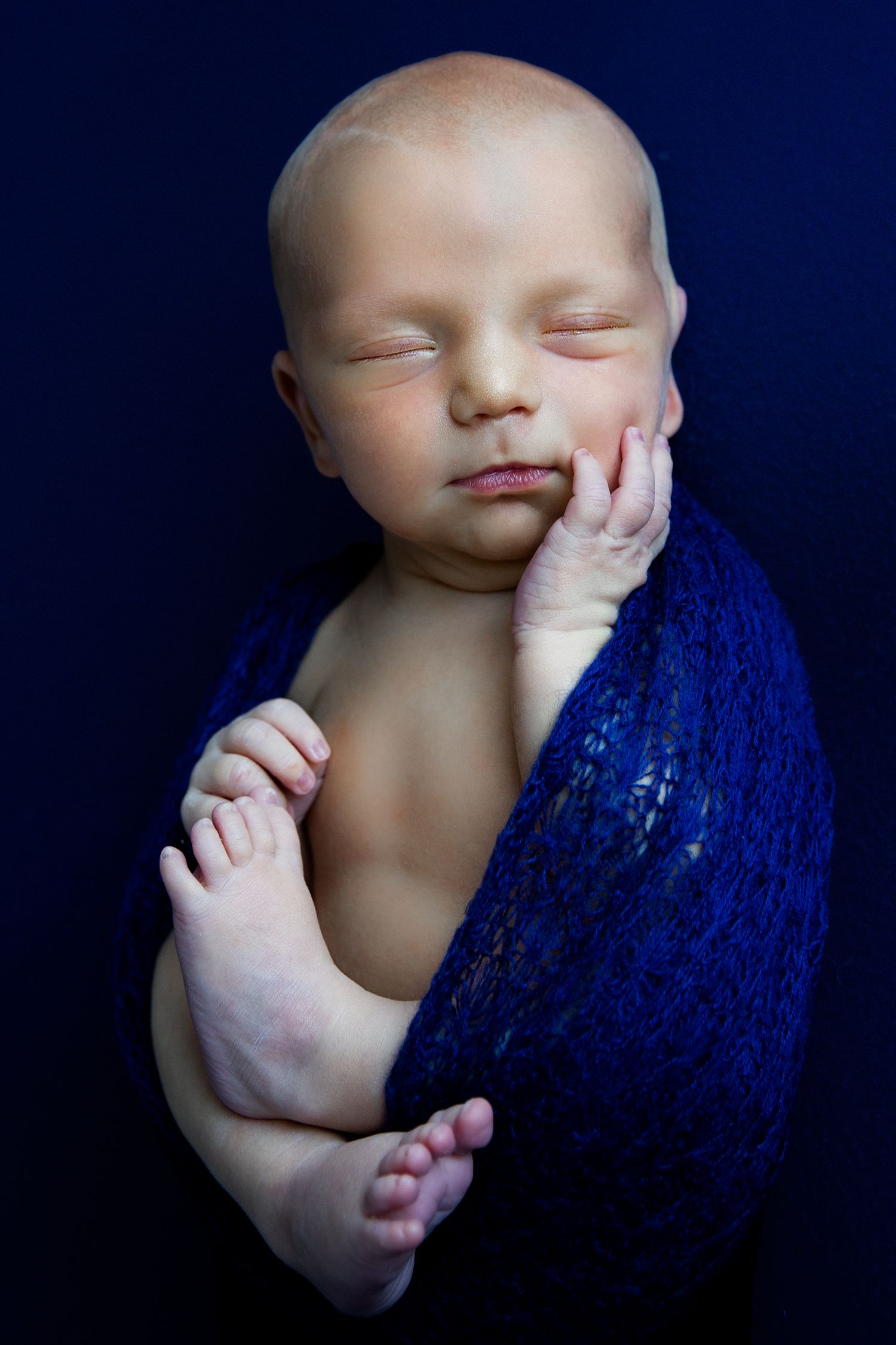 wrapped newborn boy in newborn photoshoot