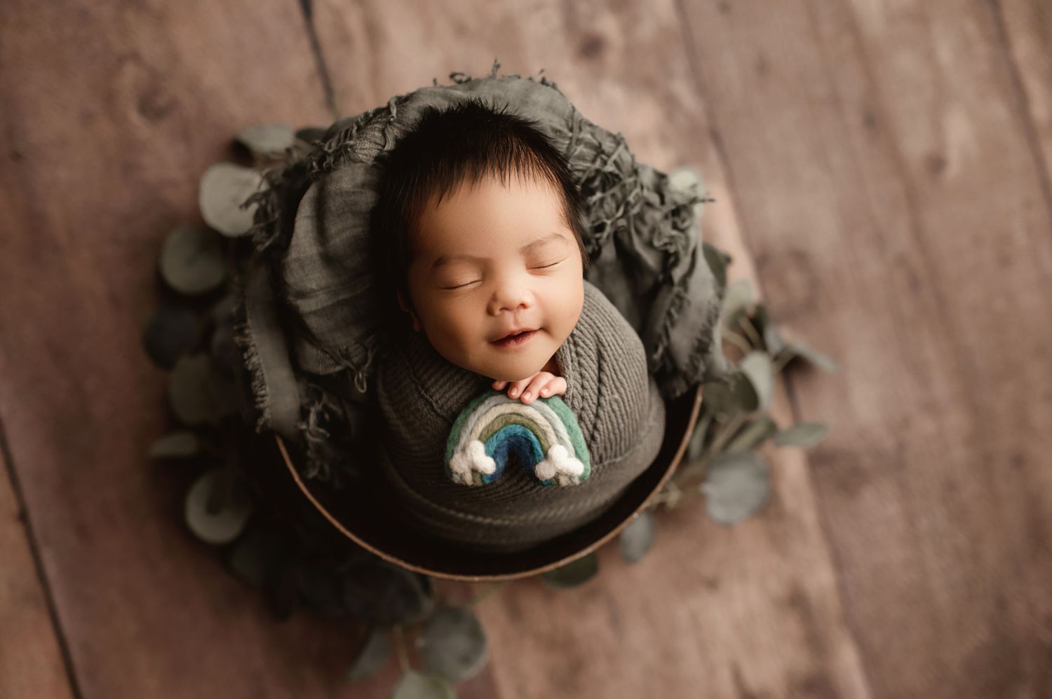 baby boy in green with smile, Moreno Valley CA newborn photographer