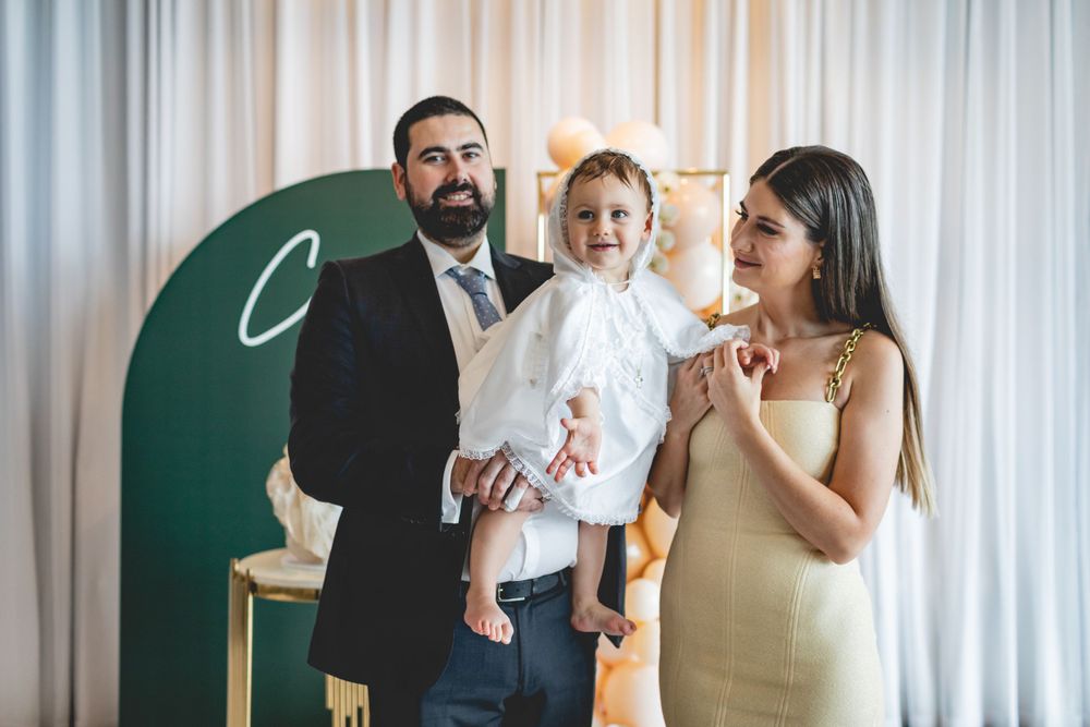 Special occasion celebration with green arch backdrop and elegant decor.