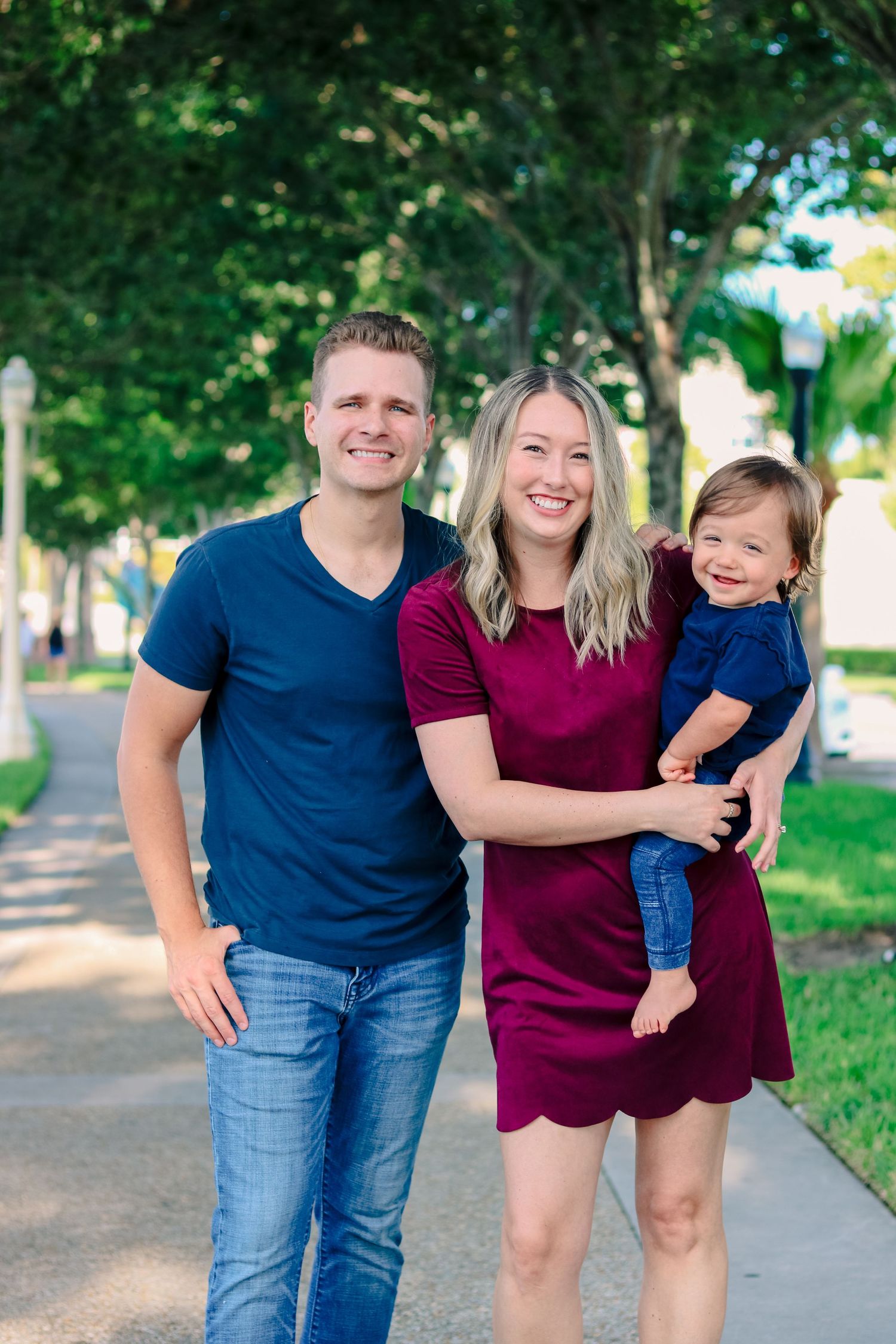 family of three smiling for a photo