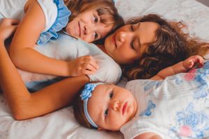 Sweet family cuddle time showing peaceful sleeping expressions.