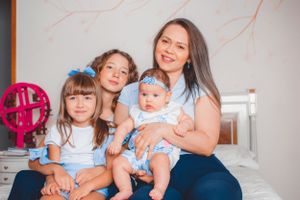Family sharing tender moments together with baby in coordinated blue and white outfits.