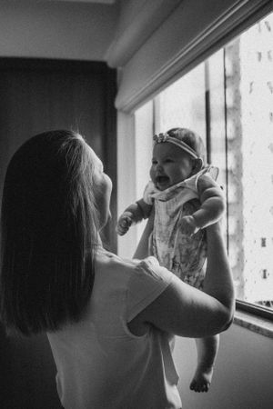Silhouetted figures share an intimate bonding moment by a window.