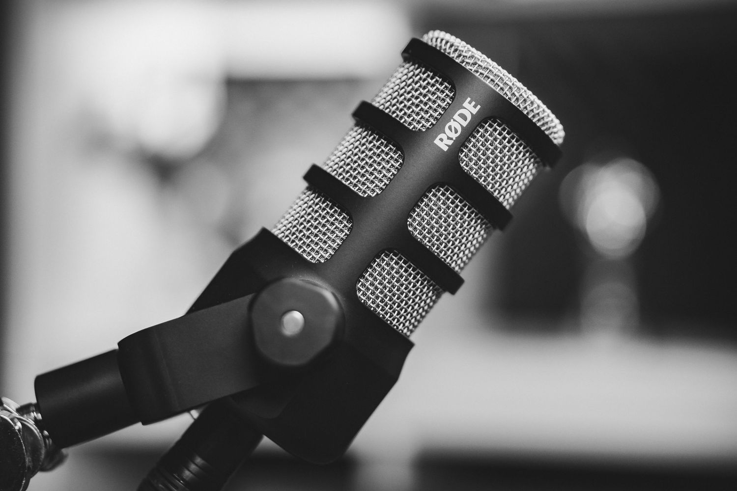 Professional condenser microphones in studio setting with blurred background.