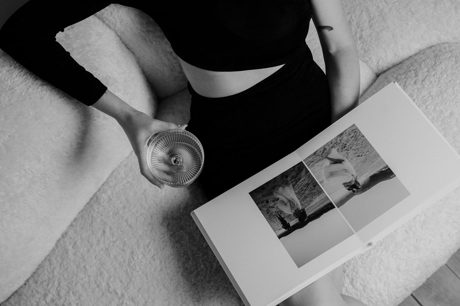 August and Vine Wedding Photography black and white of women with champagne looking through wedding album on a couch