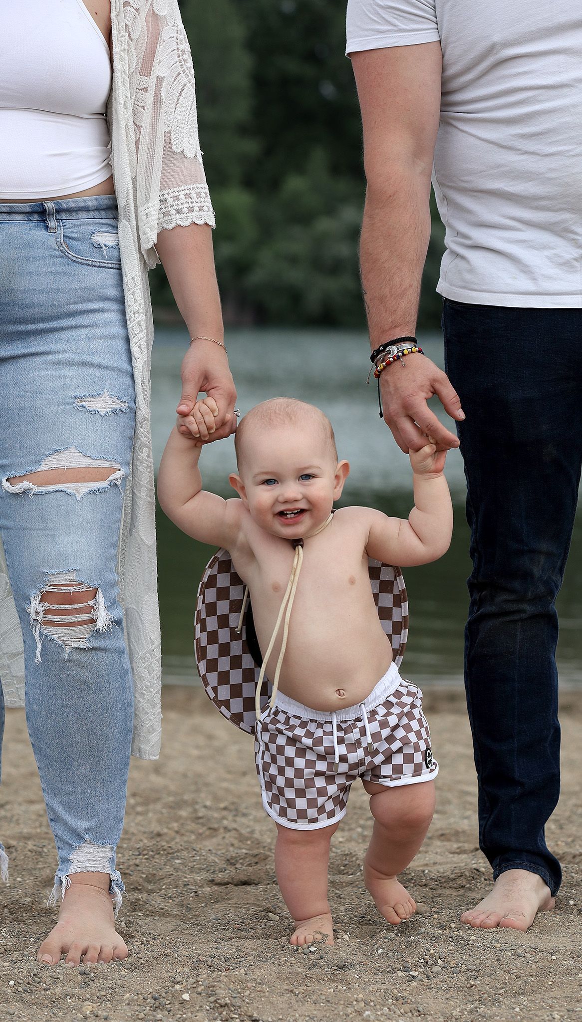 Mom, Dad and baby on a beach for one year photo