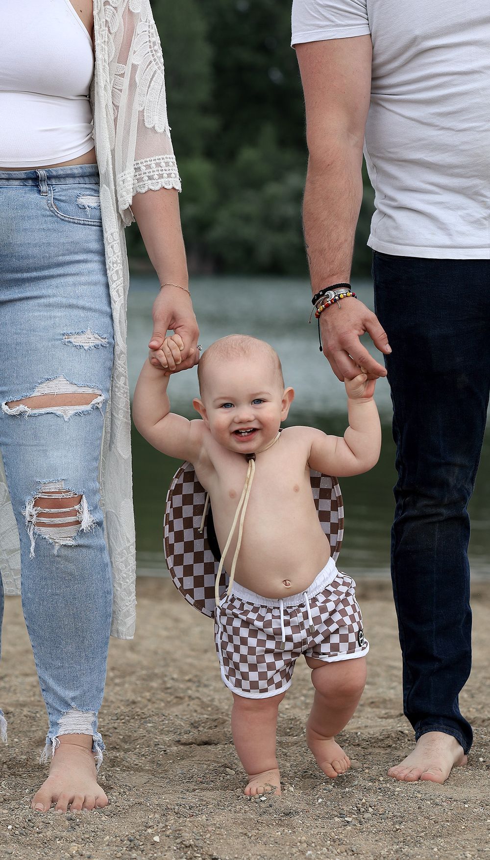 Mom, Dad and baby on a beach for one year photo