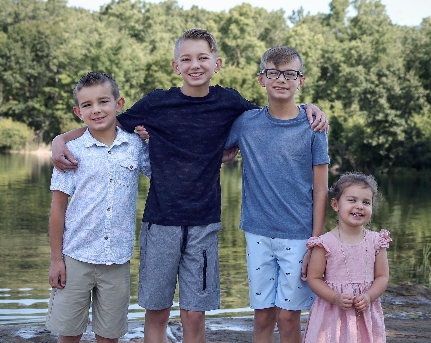 Four brothers and their cousin smiling for family photos