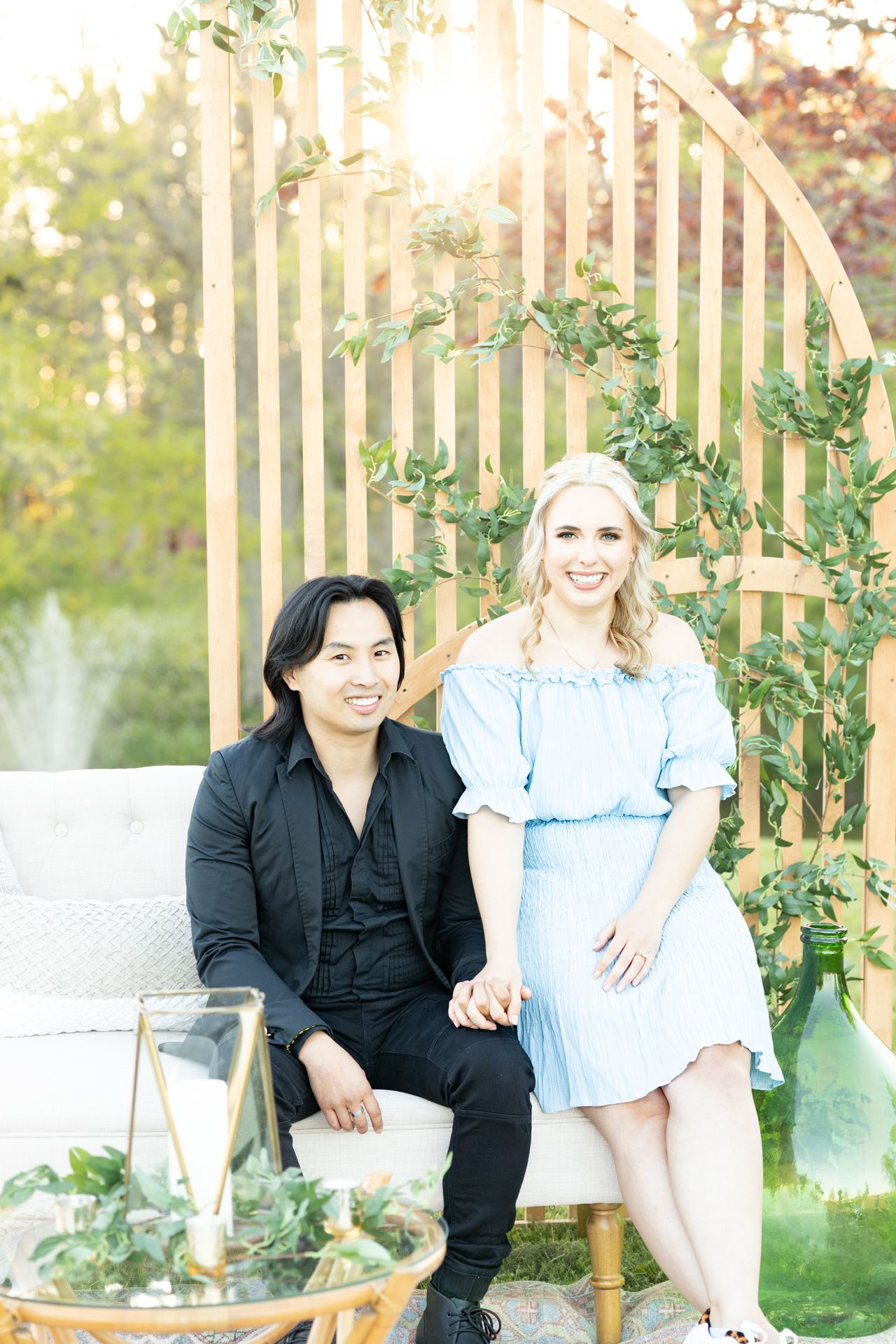 engaged couple with intimate backyard wedding decor set up