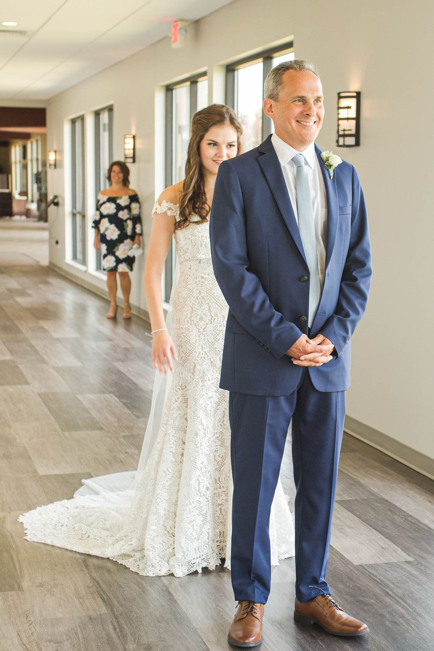 Bride and dad first look with mom looking on