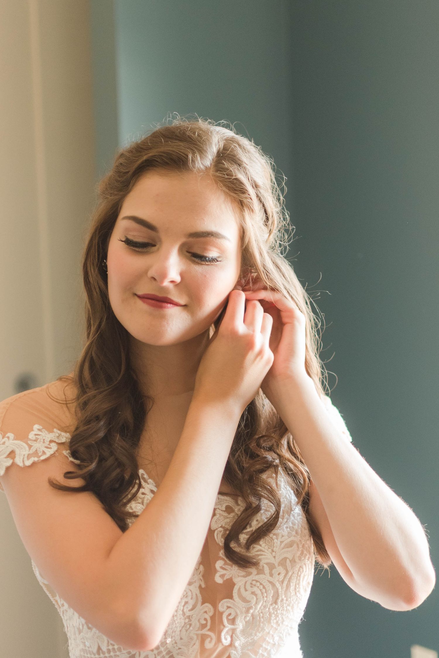 Bride putting on jewelry portraits