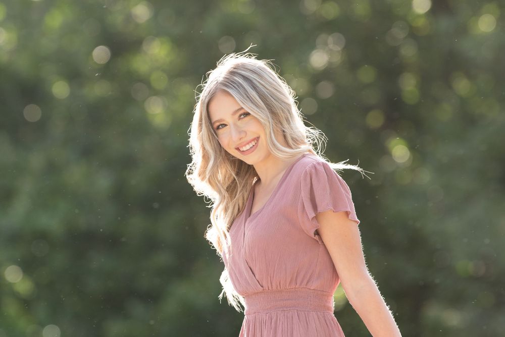 high school senior girl photoshoot, day time with sun on her back lit