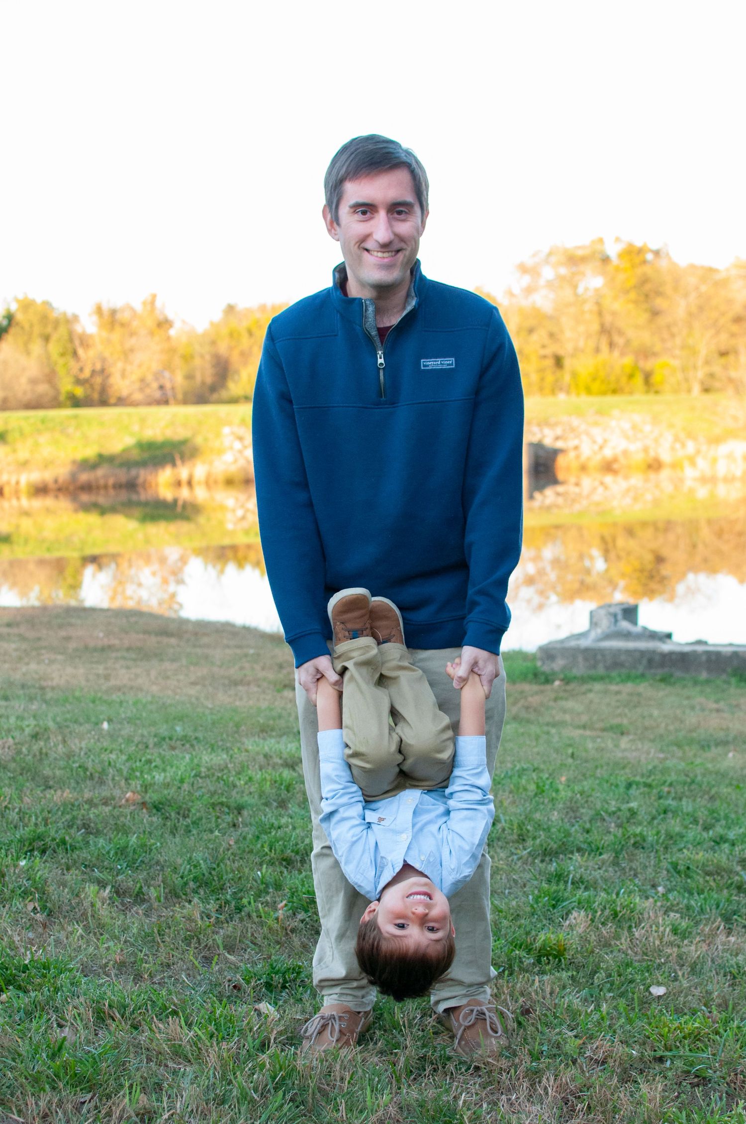 Dad holding child upside down