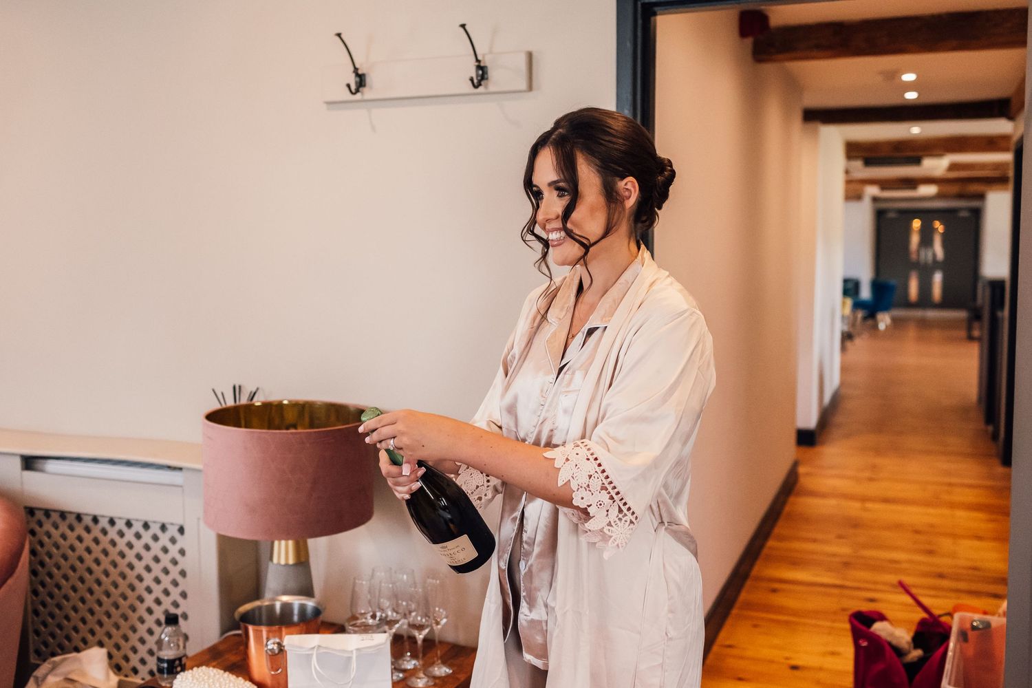bridesmaid popping champagne