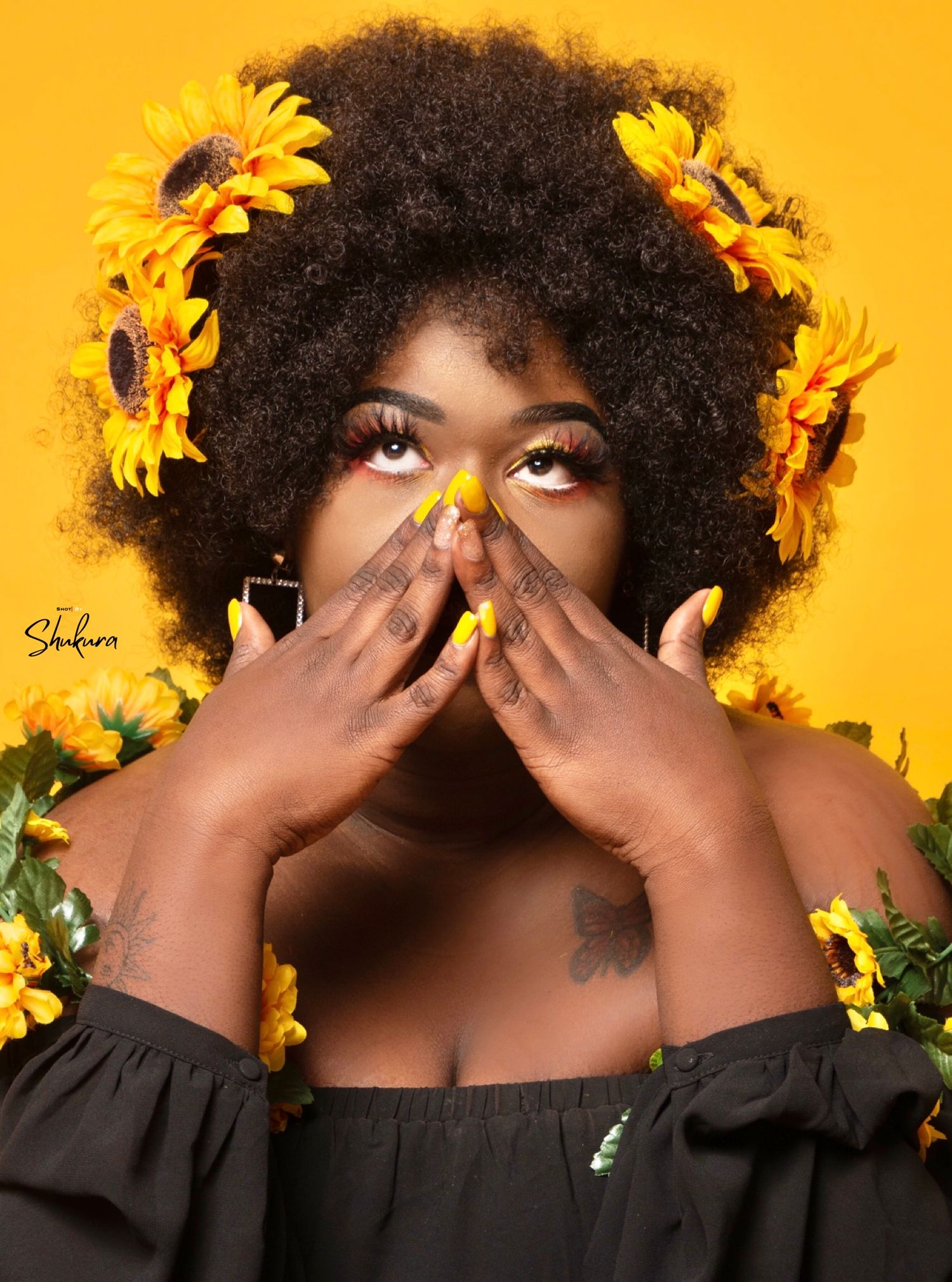 Artistic sunflower-themed portrait against vibrant orange background.