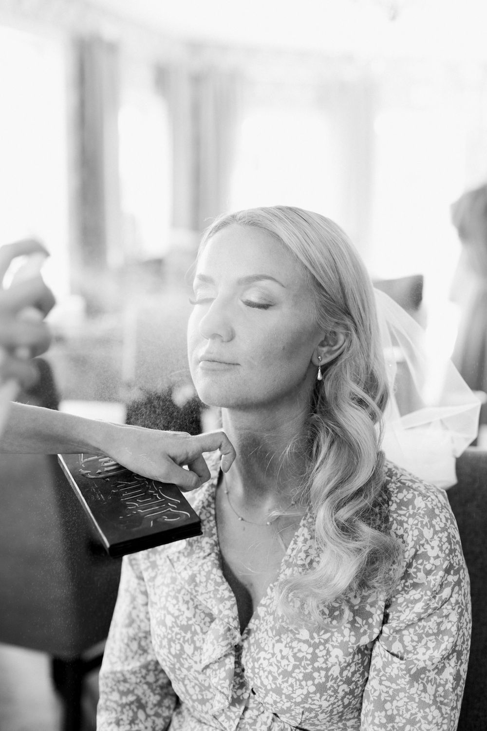 A candid black and white photograph showing preparation moments before a special event.