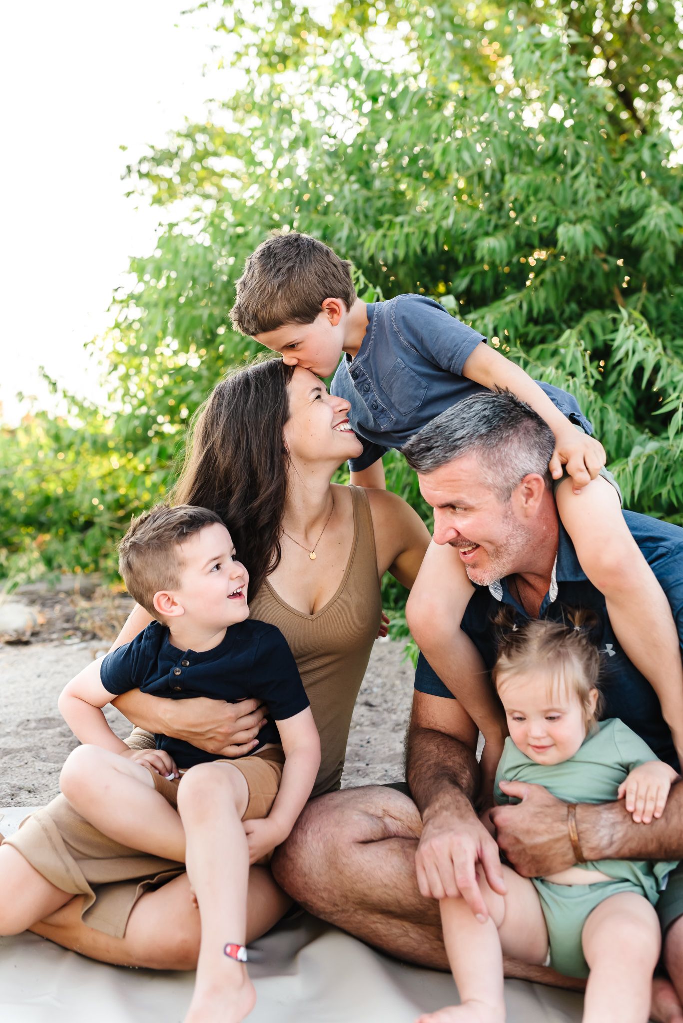 Casual outdoor family photo session showing candid moments of interaction and laughter.