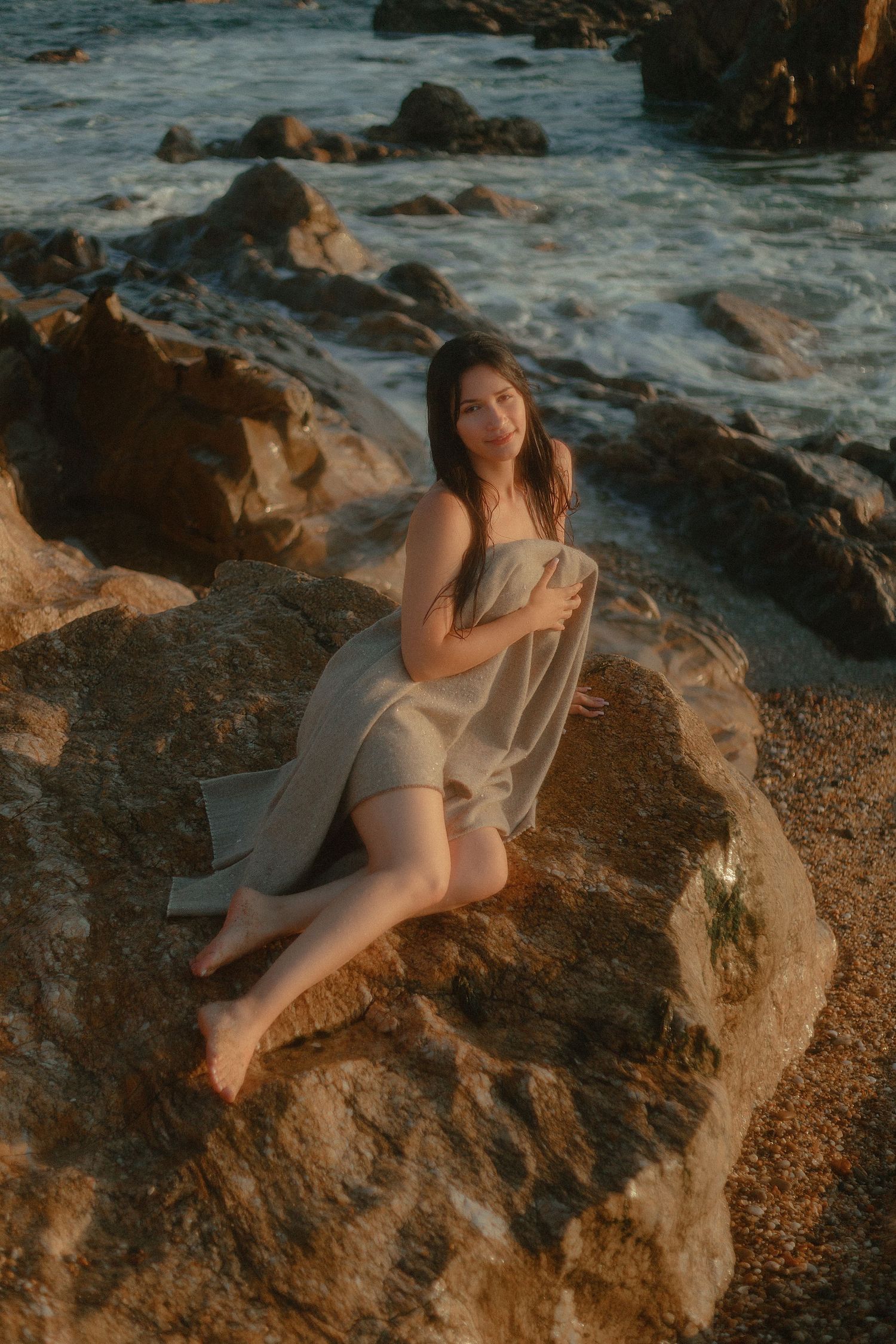 mulher em rochas na praia coberta sereia selkie transformada humana pernas mitologia selkiecore mermaidcore fantasia