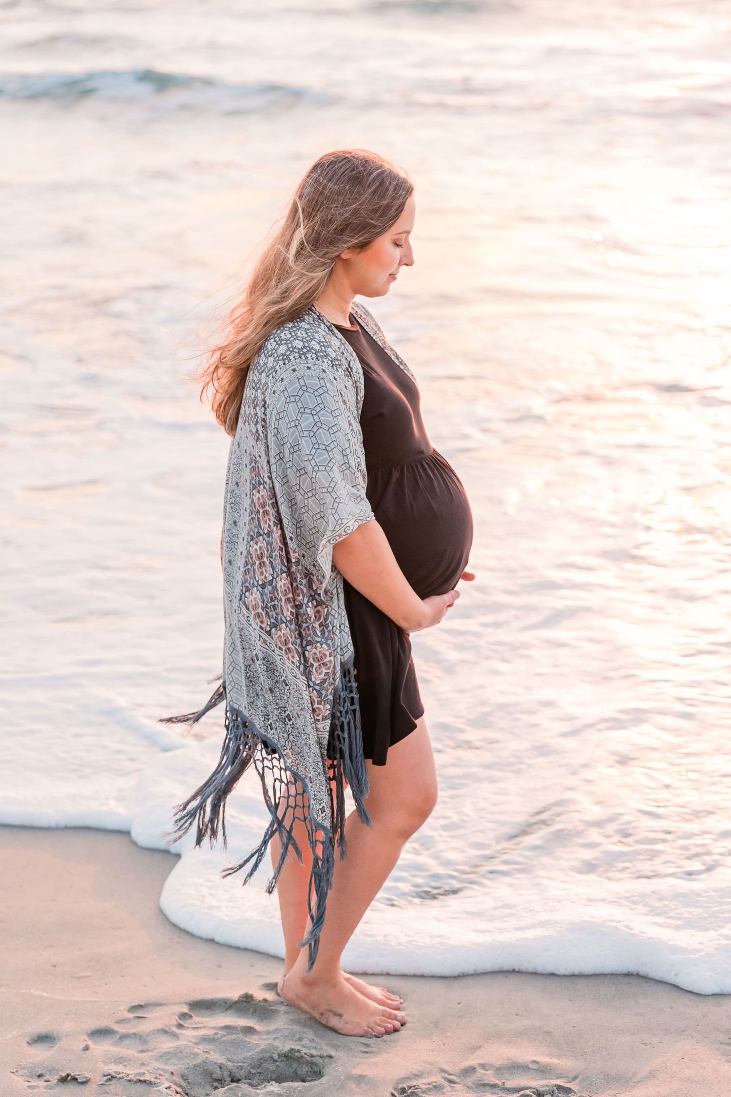 pregnant mom holding bell yon beach at sunrise, Maternity Photographer, Satellite beach, FL