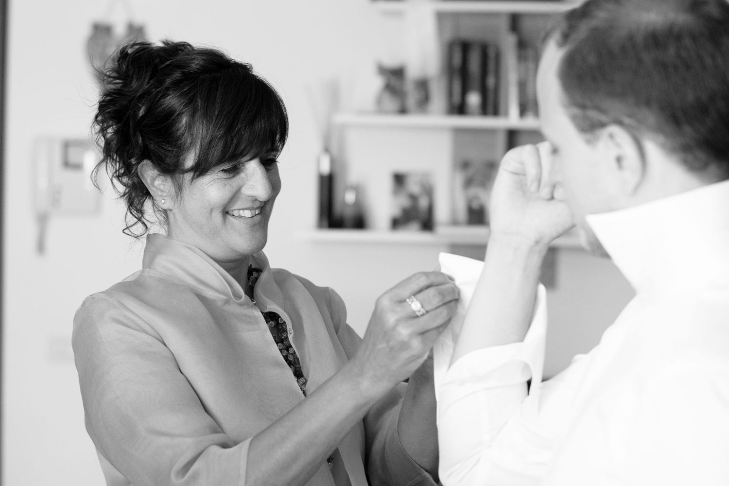 Black and white photo showing two people getting ready in a candid moment.