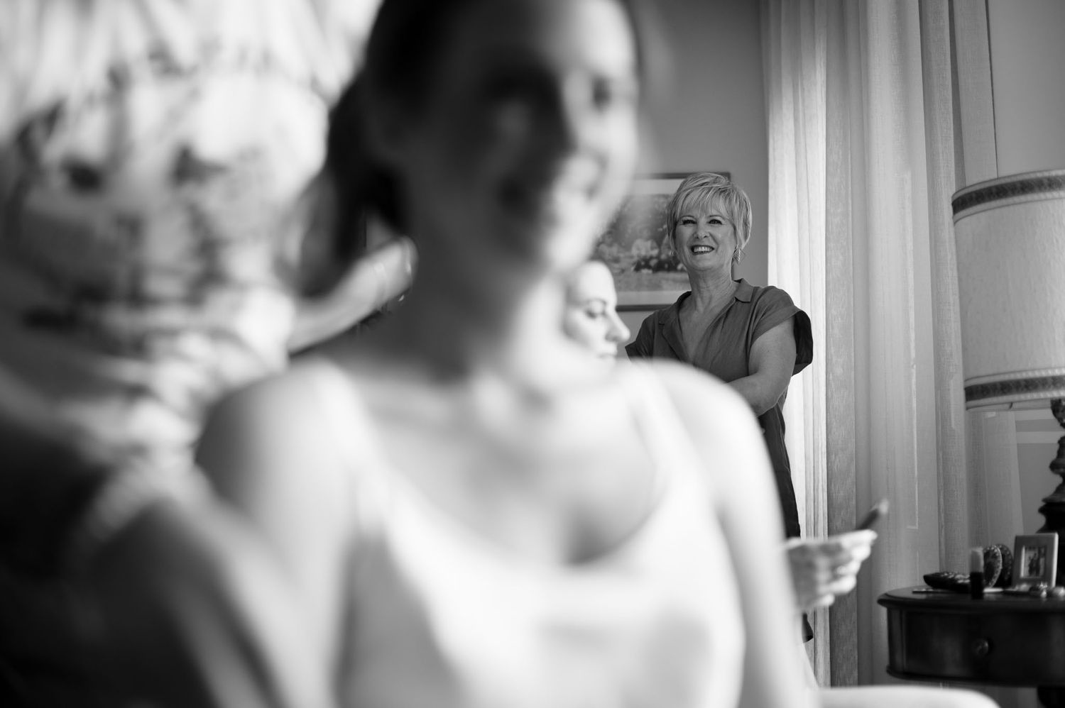 Black and white candid moment during wedding preparations.