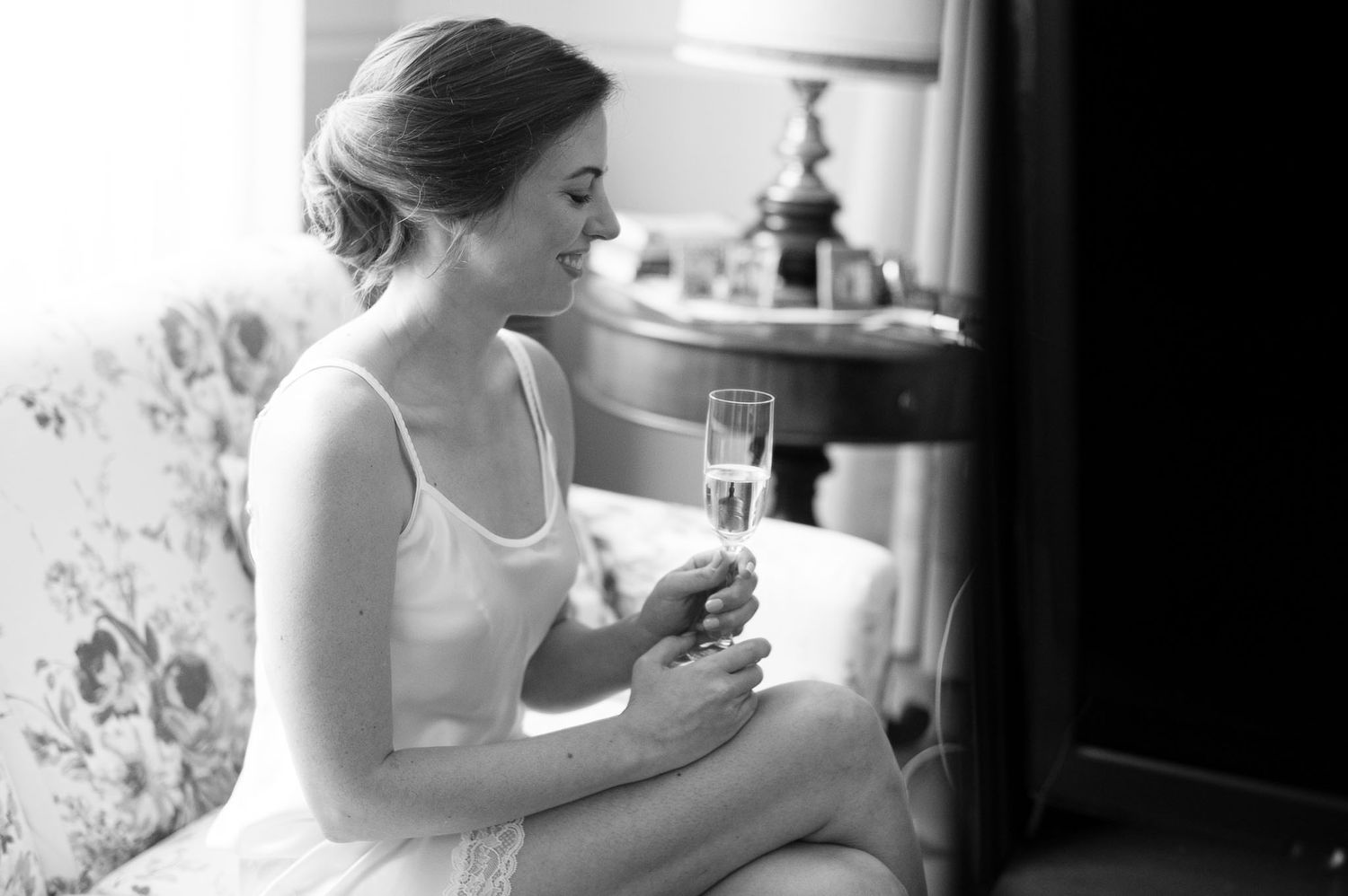 Black and white image showing quiet moment with champagne glass.