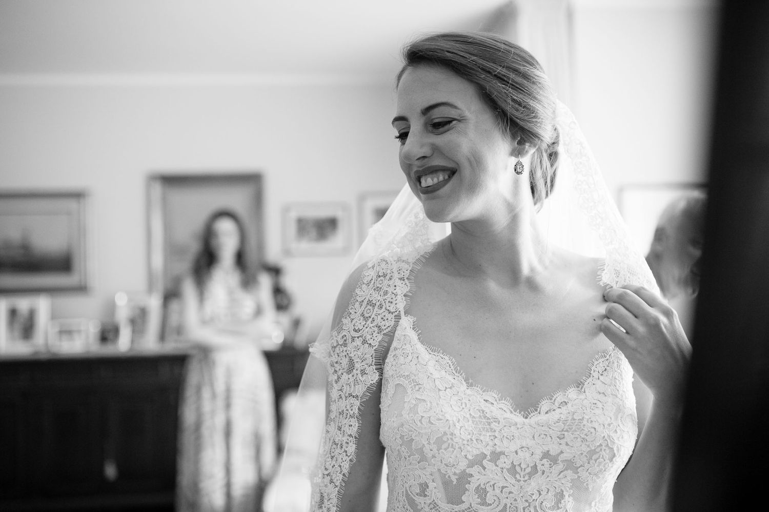 Black and white candid moment showing joy during wedding preparations.