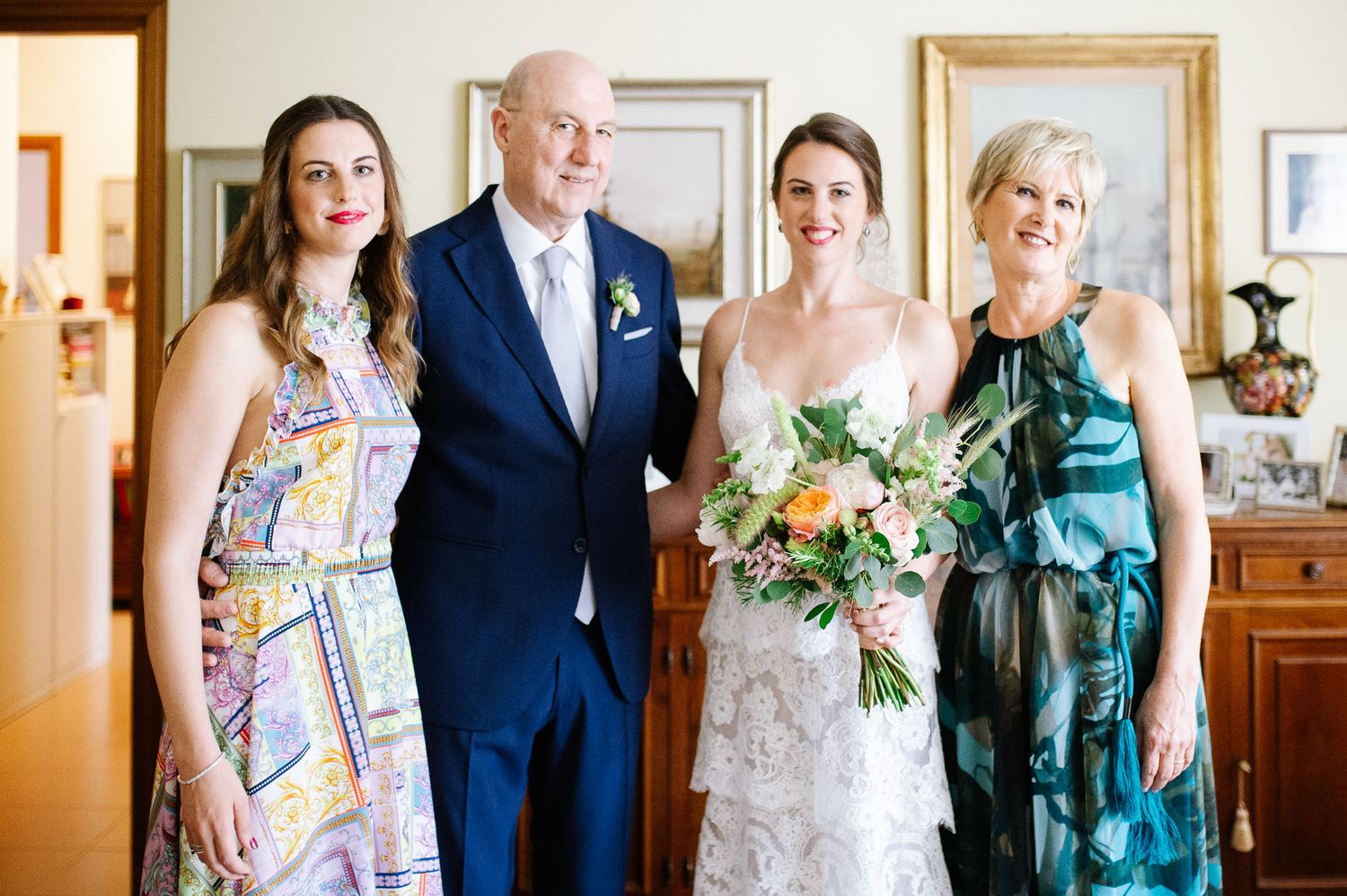 Wedding party poses in formal attire before the ceremony.