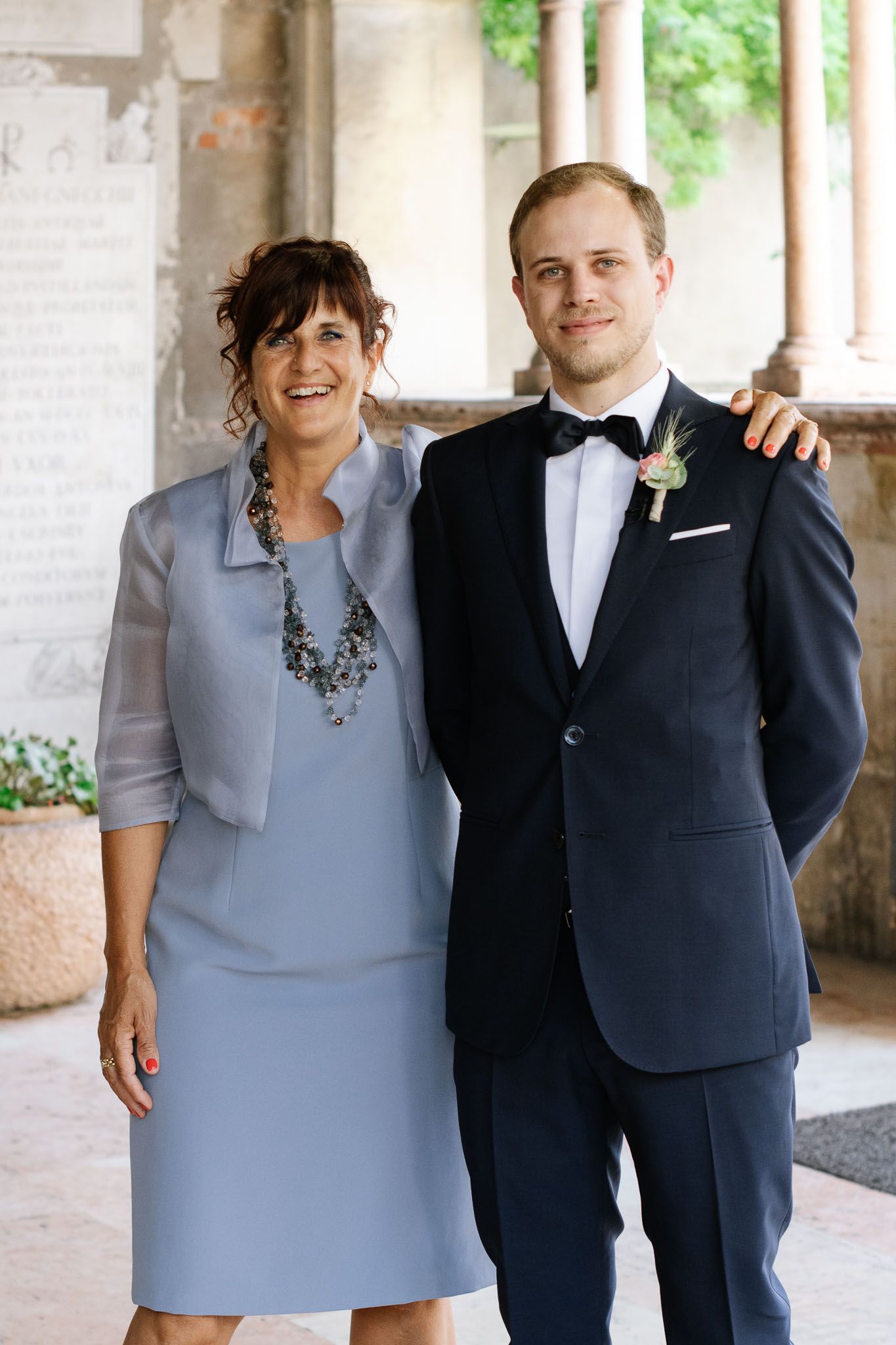 Formal portrait taken under a columned portico.