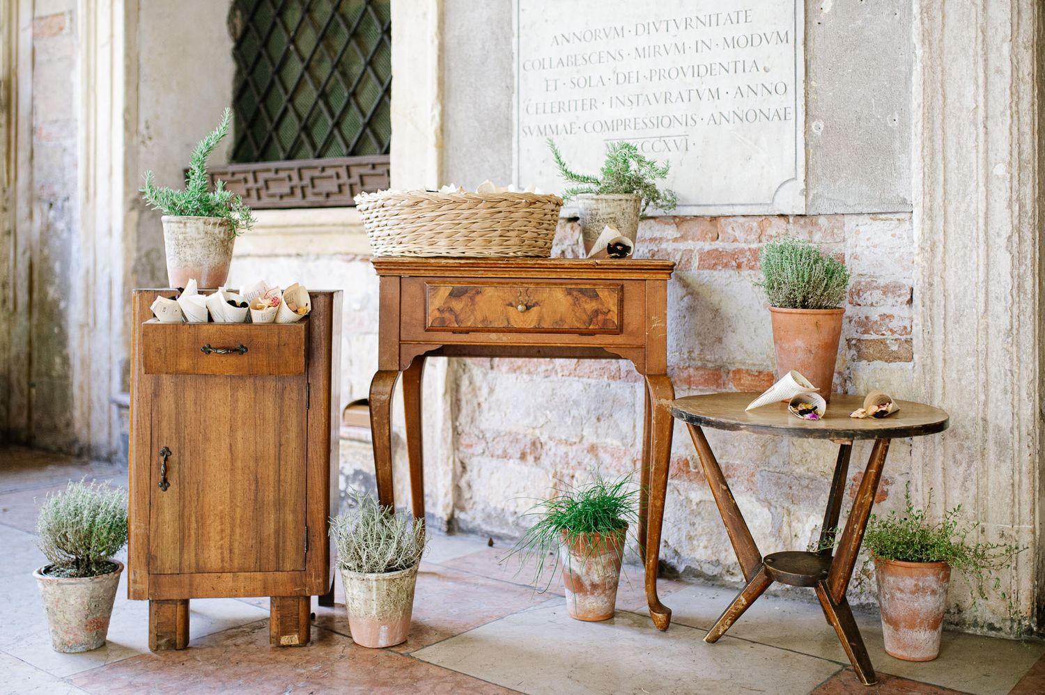 Rustic wooden furniture and potted plants create a charming outdoor vignette.
